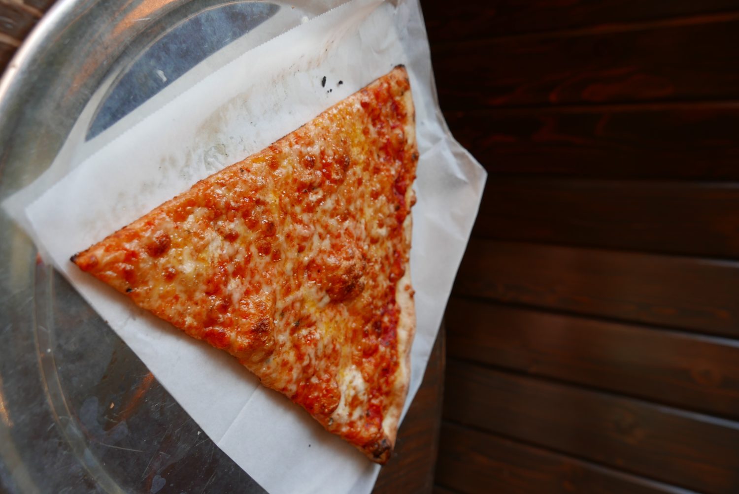 A Pizzanista slice of pizza on a tray.