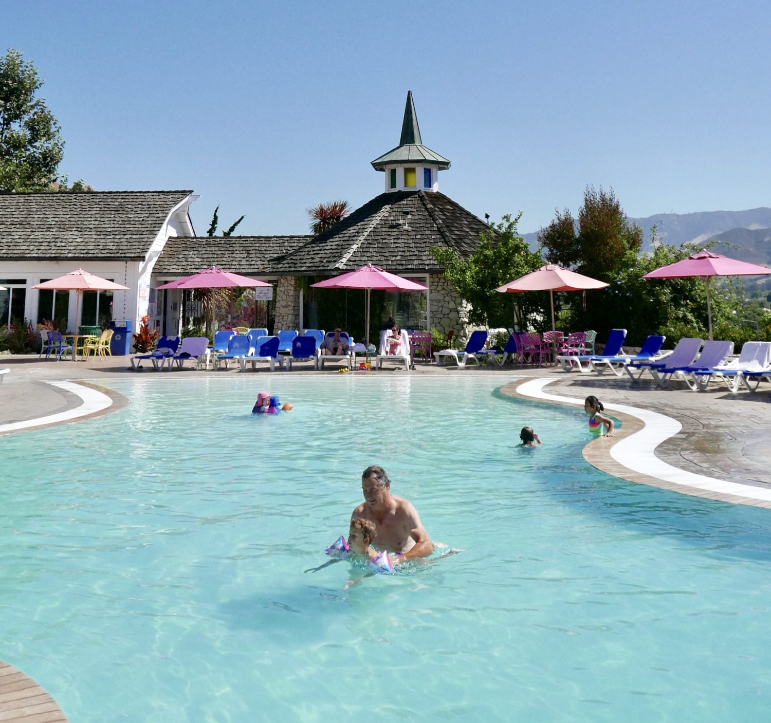 The Madonna Inn, a swimming pool with people in it.