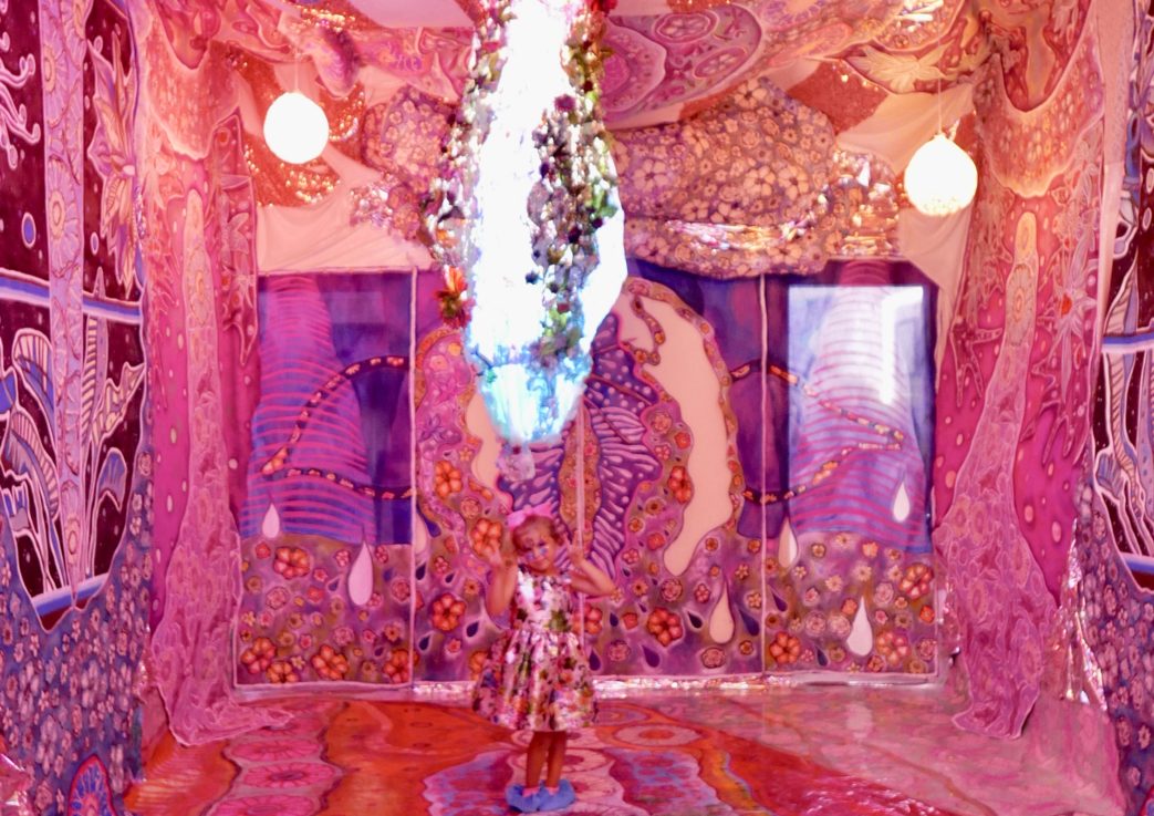 Radiant Space Gallery is a mesmerizing room adorned with an abundance of pink and purple decorations.
