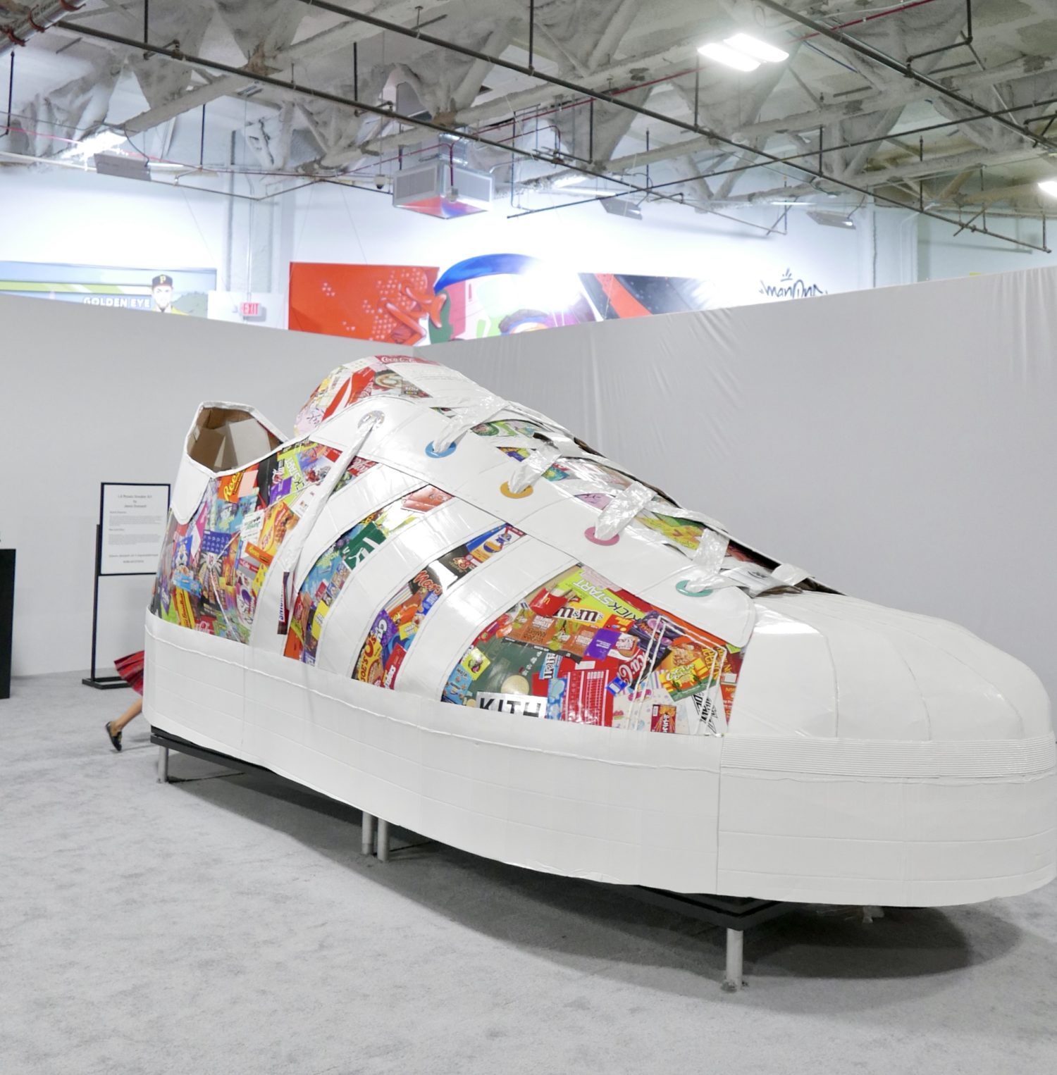 Sneakertopia, a large white shoe adorned with various designs.
